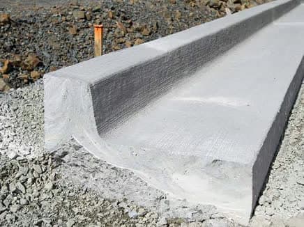 Extruded concrete curb and gutter alongside a new roadway