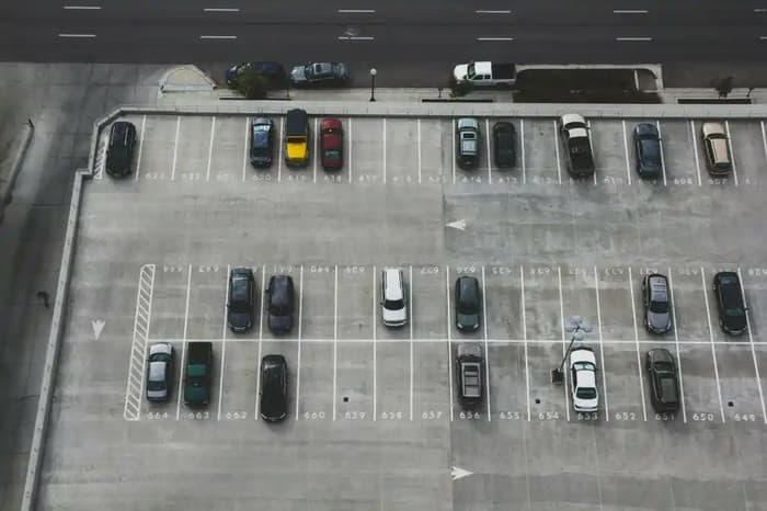 Aerial view of a striped parking lot with numbered spaces