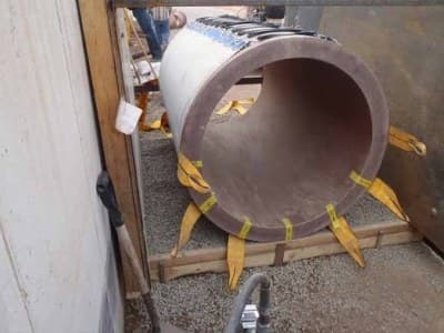 Grout bedding beneath a length of underground pipe