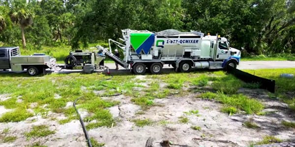 Quality-Crete truck parked on a green lot