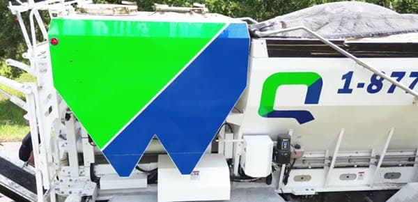 Close-up of the Quality-Crete logo on a mixer truck