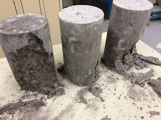 Broken concrete cylinders after compressive strength testing