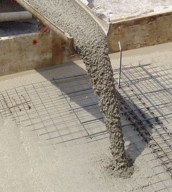 Concrete chute placing a structural pour over rebar