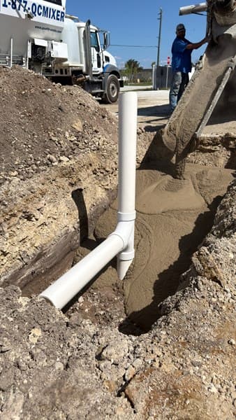Trench with pipework beside a formed concrete pour
