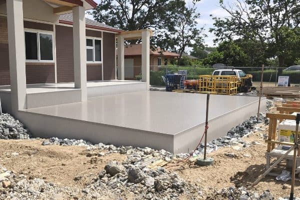 Freshly finished slab beside a new home