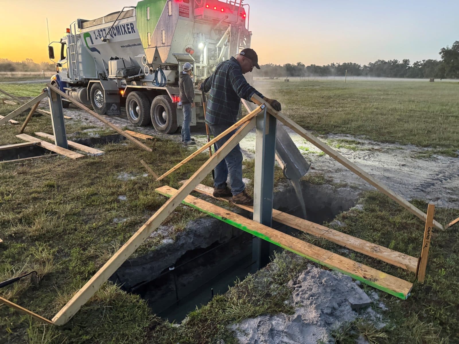 Quality-Crete driver placing concrete into residential footing forms