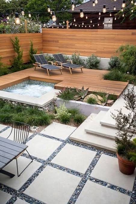 Backyard spa with concrete paver deck